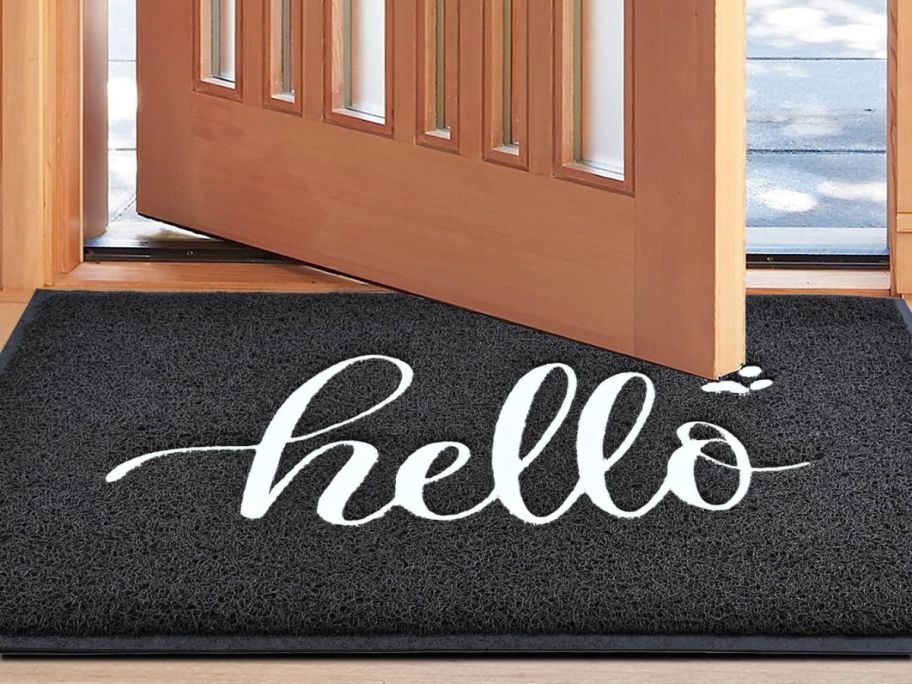 A black and white door mat that says 