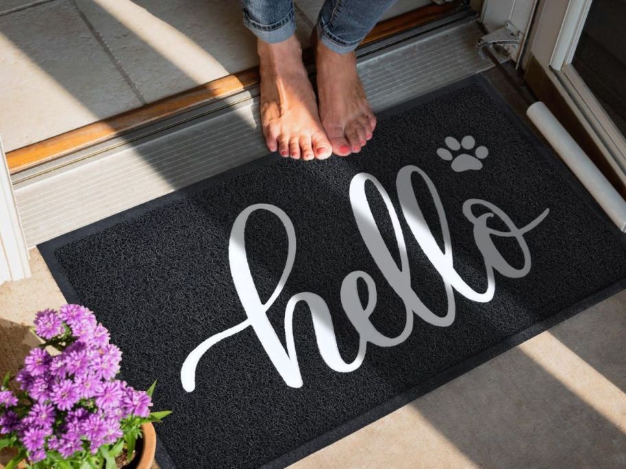 A black and white door mat that says 