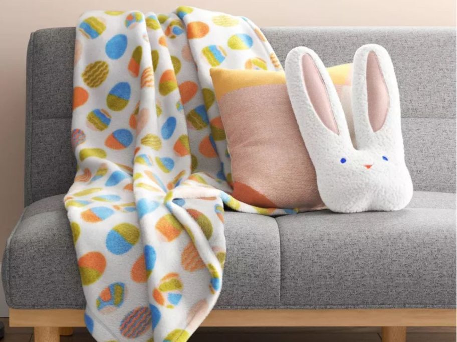 Room Essentials Egg Easter Throw and Bunny Throw Pillow on a couch