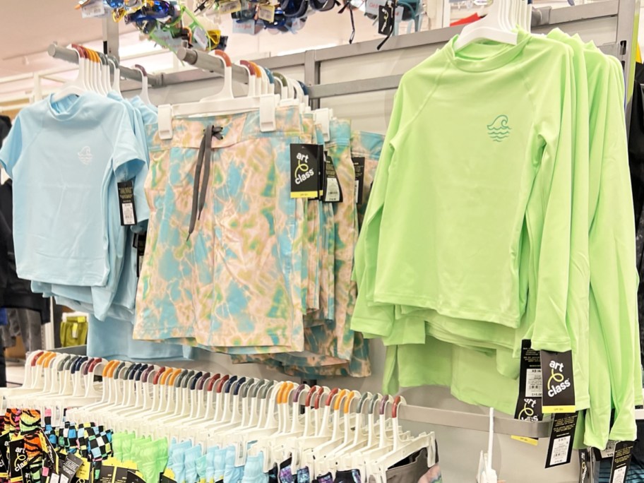 boys rash guards and swim shorts on display in store
