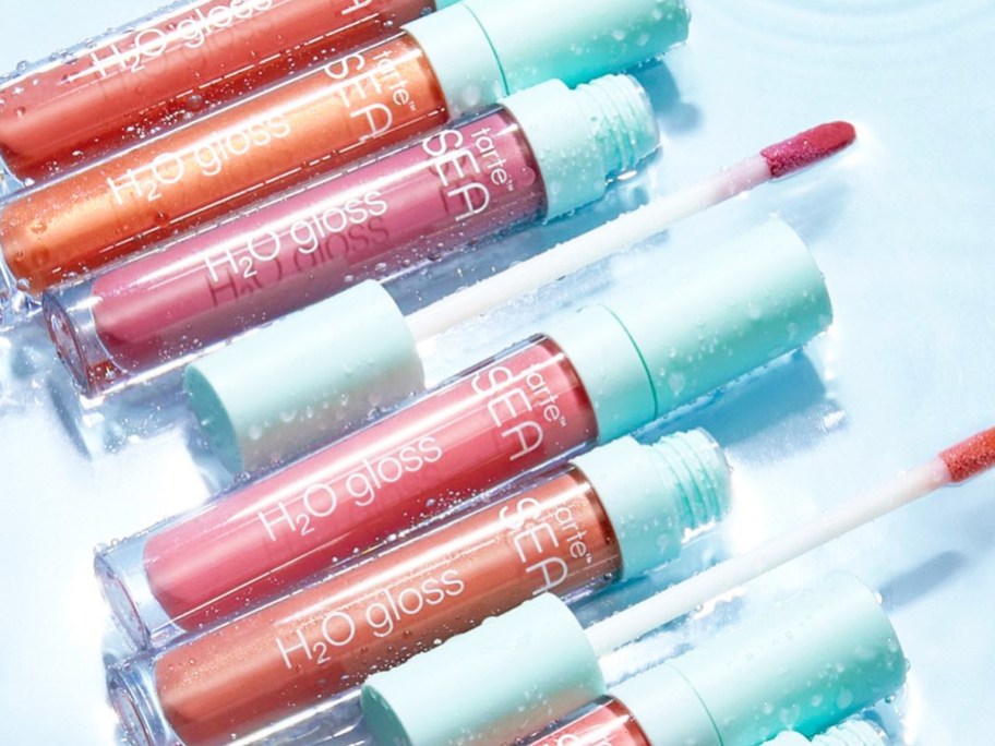 multiple shades of Tarte H₂O Lip Glosses in water