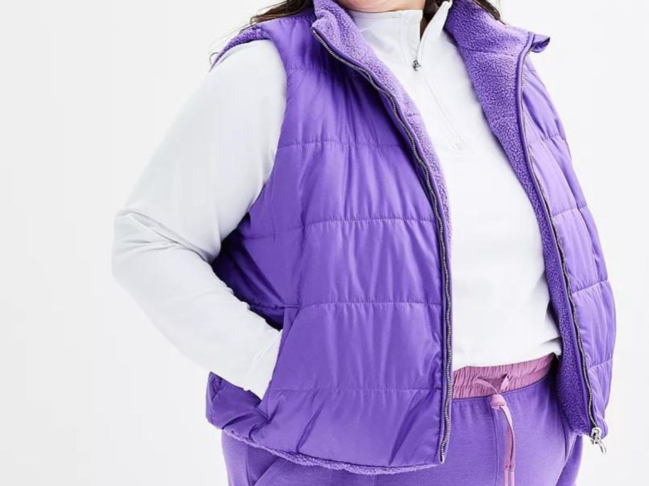 A woman wearing a purple Tek Gear Plus Sized Cropped Reversible Vest