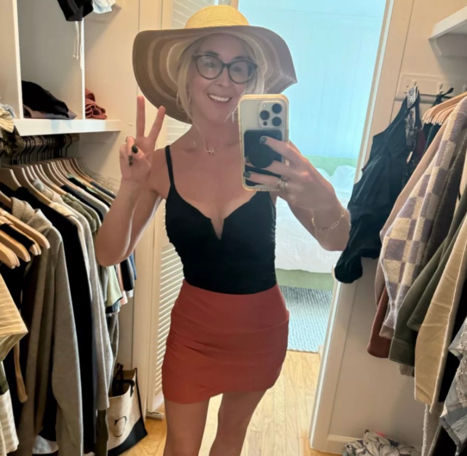 woman wearing floppy hat and bathing suit in walk in closet