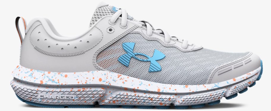 light grey under armour running shoe with paint splatter on the sole