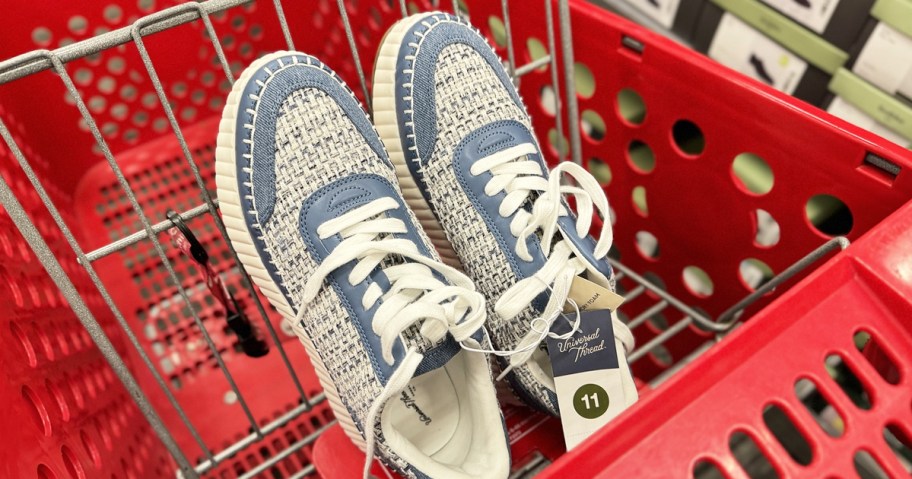pair of white and blue sneakers in red target shopping cart