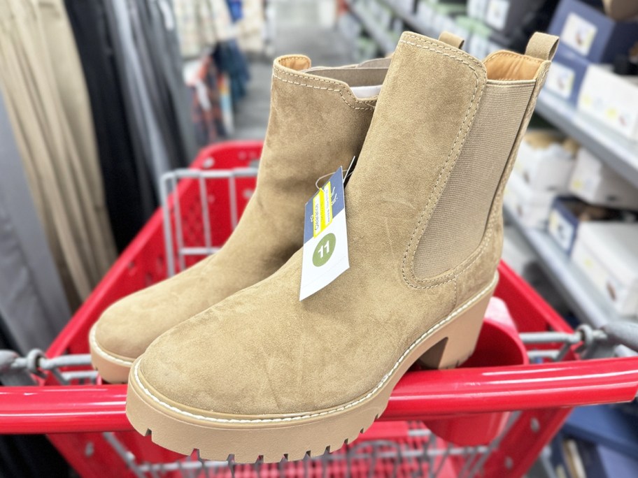 light brown pair of boots on top of red target shopping cart