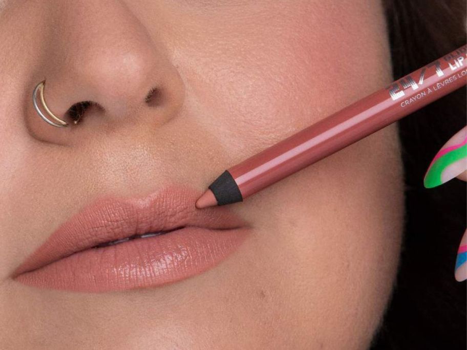 woman applying an Urban Decay Lip Liner