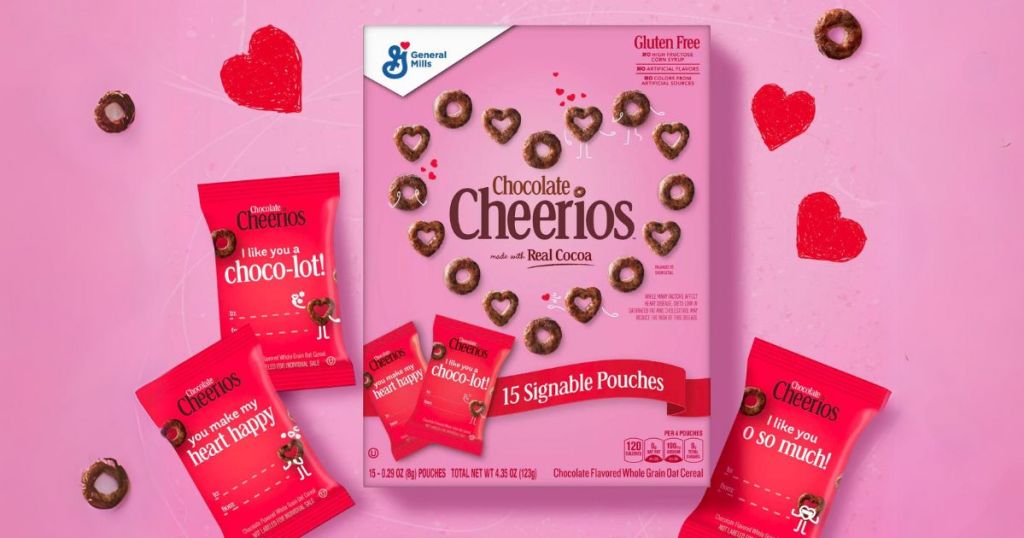 a box of Valentine's Chocolate Cheerios with individula red pouches of cheerios on a pink background