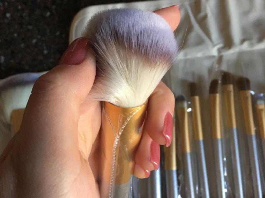 Hand holding a Vander makeup brush and showing the quality of the bristles