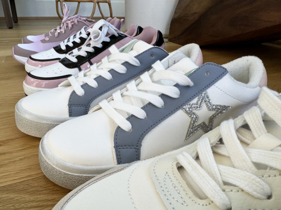 row of sneakers on hardwood floor