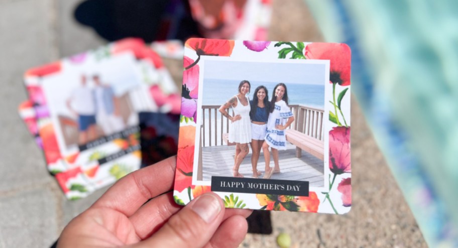 Woman holding Mother's Day coasters with background on the pool