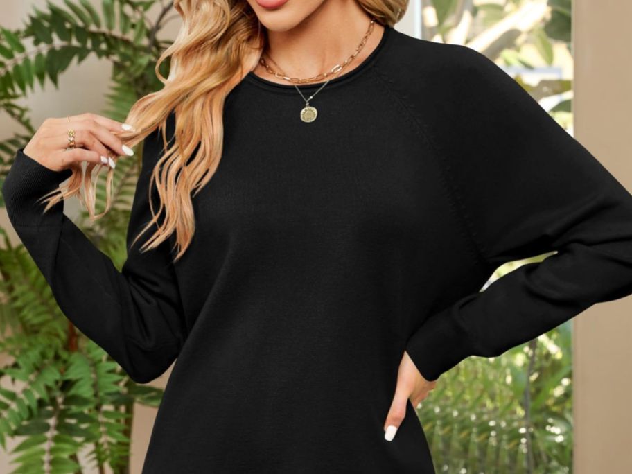 A woman wearing a ZESICA Oversized Crew Neck Sweater in black