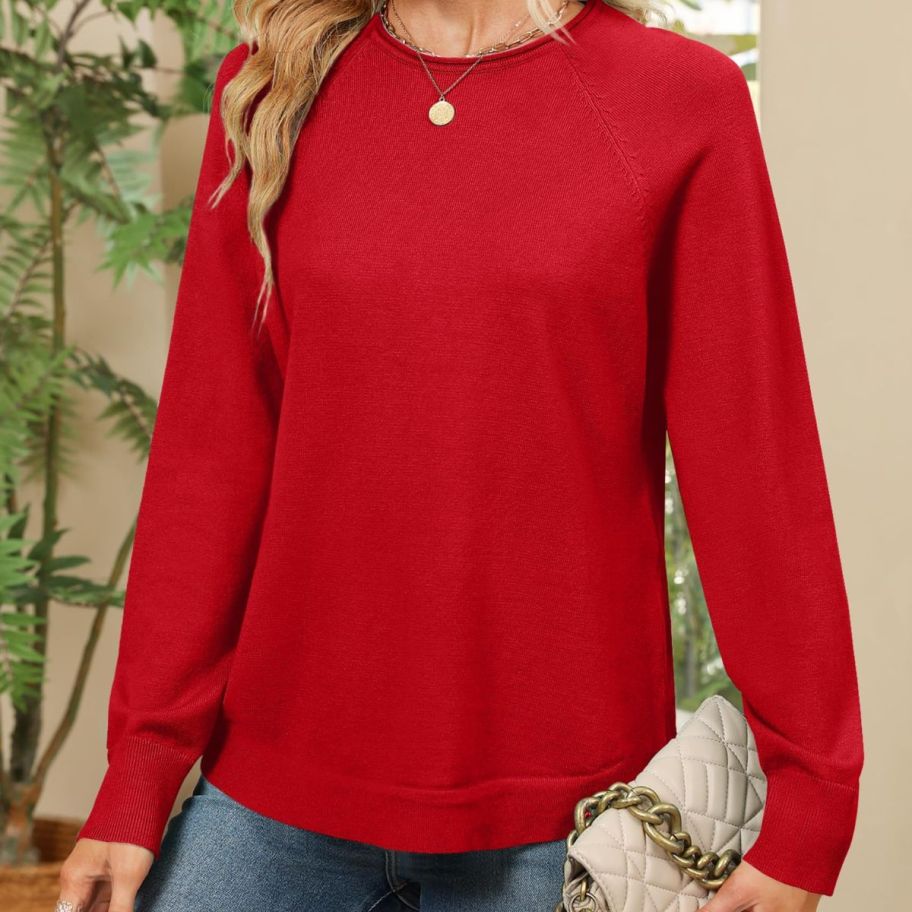 A woman wearing a ZESICA Oversized Crew Neck Sweater in red