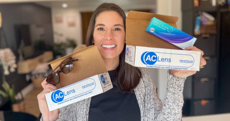 Emily holding up boxes from AC Lens with prescription sunglasses and contacts