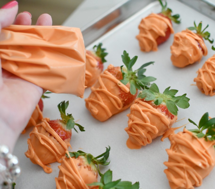 adding lines across orange strawberries with orange candy melts