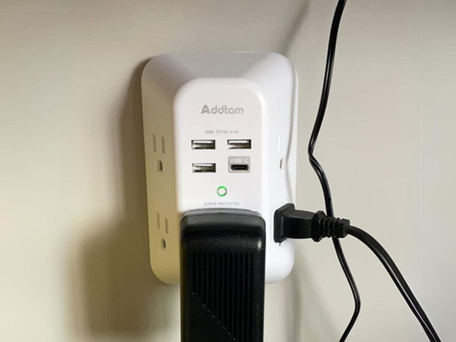 outlet extender plugged into wall with multiple devices plugged in