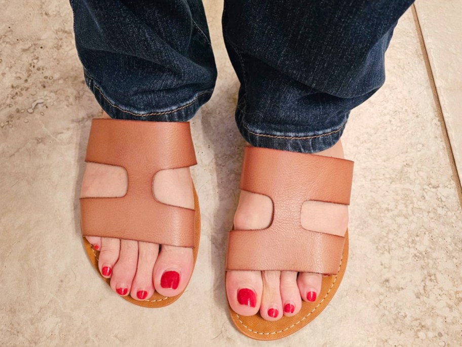 woman wearing tan sandals with jeans