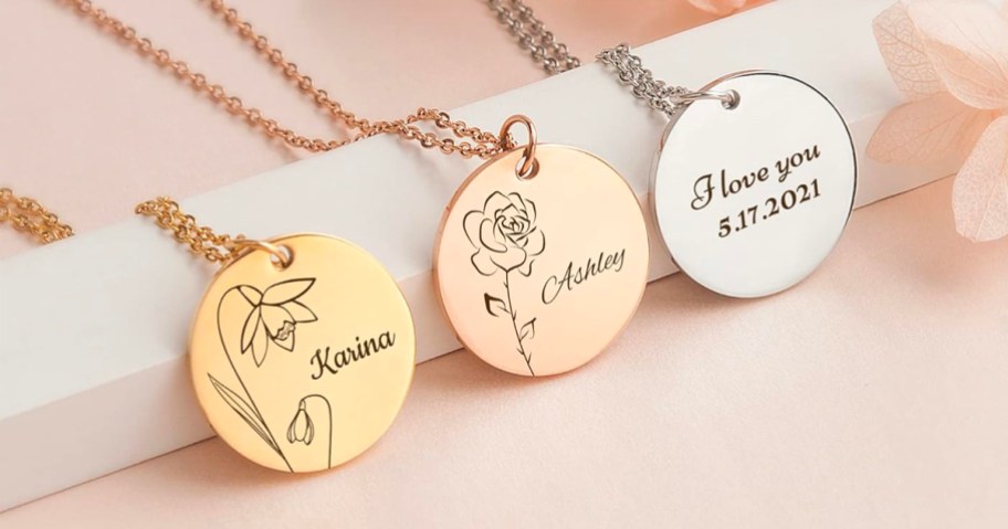 gold, rose gold, and white gold disc necklaces with flowers and names 