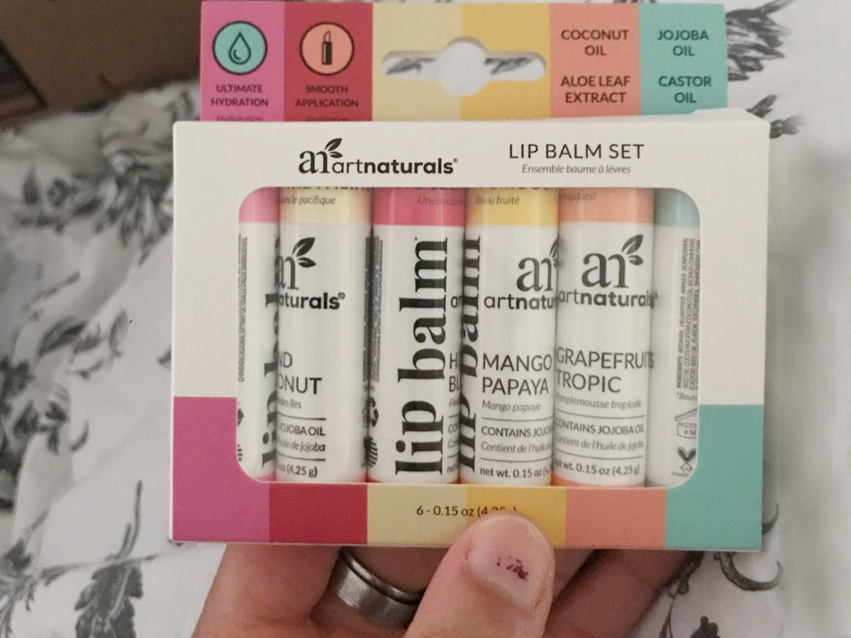 hand holding artnaturals lip balm in giftset box