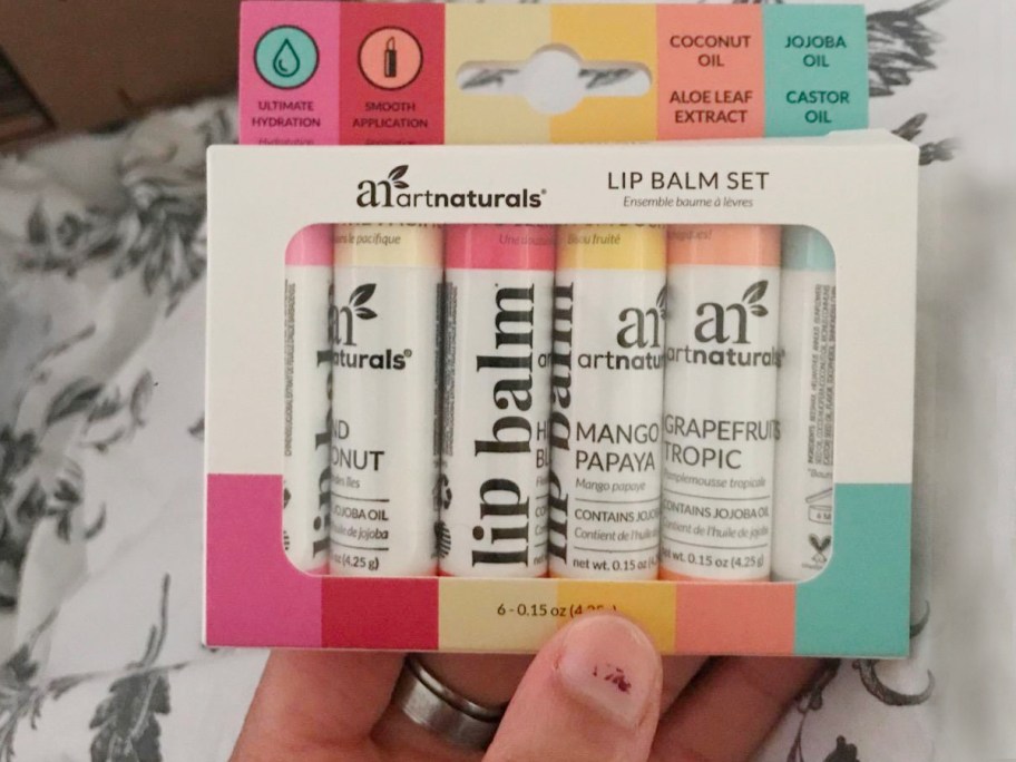 hand holding artnaturals lip balm in giftset box