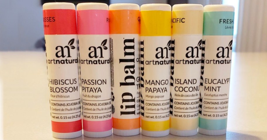 six artnaturals lip balms standing up on countertop
