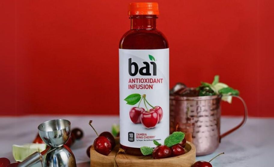 a bottle of bai bing cherry infused water shown with barware