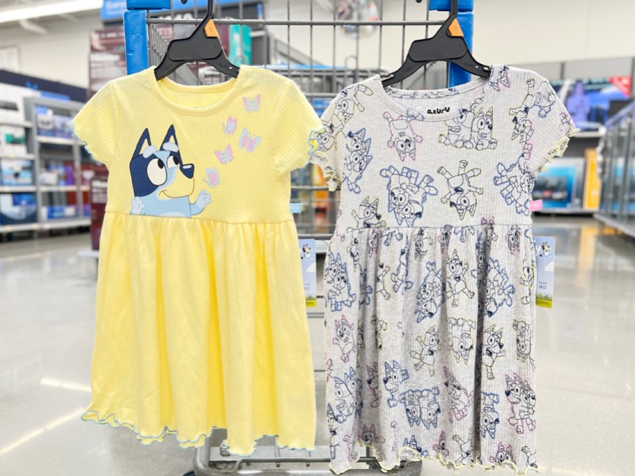 yellow and blue bluey dresses hanging on walmart shopping cart