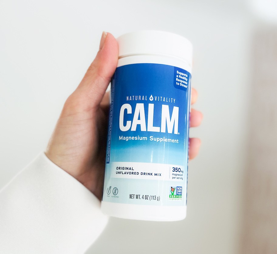 hand holding a container of calm magnesium supplements