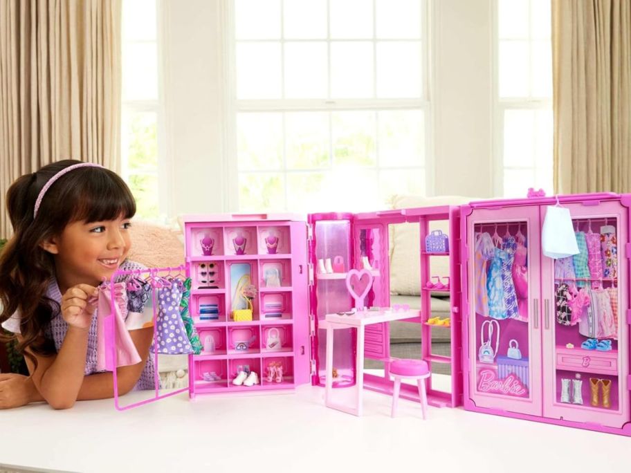 child looking at barbie closet playlet