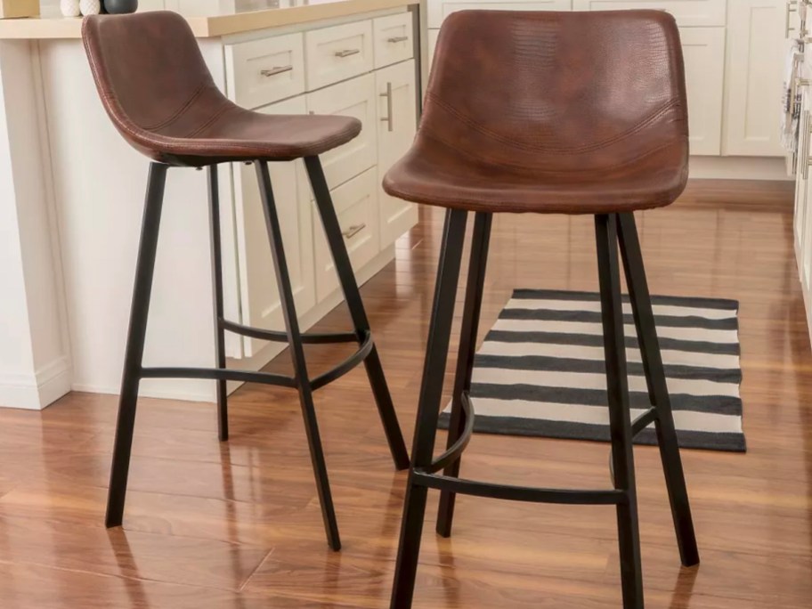two metal and brown leather barstools in living room
