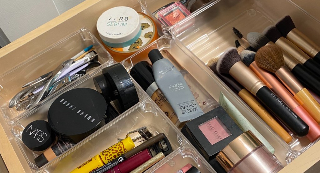 clear organizers with makeup items neatly placed inside of them
