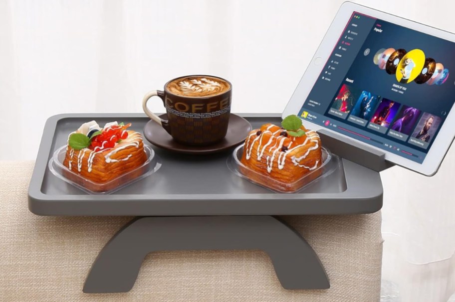 clip table with treats, coffee and a tablet on it