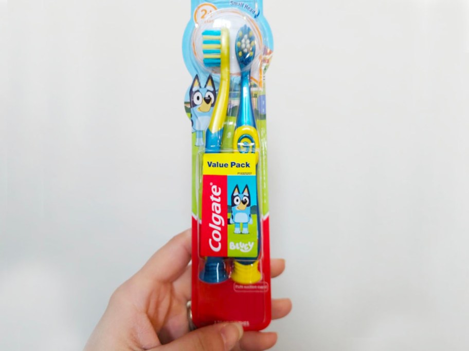 hand holding colgate bluey toothbrush 2pack