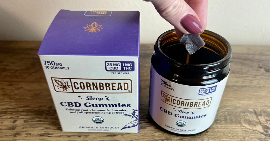 hand taking cornbread gummies out of bottle next to box