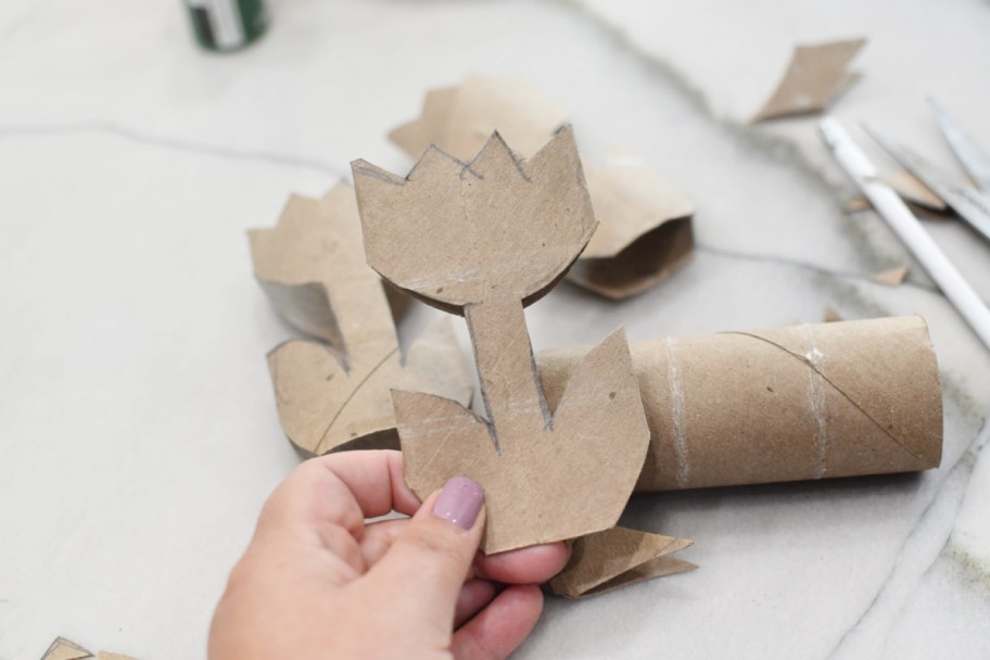 cutting out a tulip shape from toilet paper roll