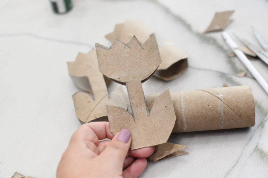 cutting out a tulip shape from toilet paper roll