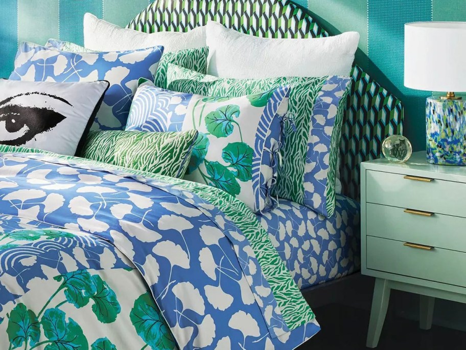 floral green and blue bedding on bed