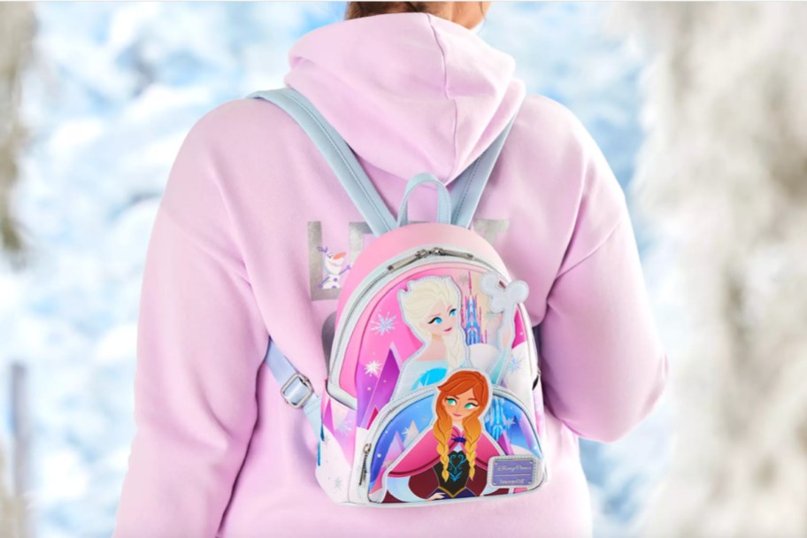 girl in pink hoodie with frozen mini backpack