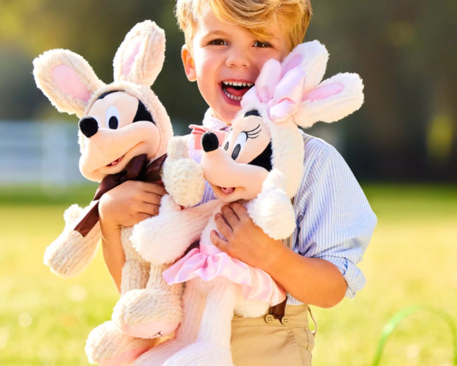 boy holding mickey and minnie easter bunny plush