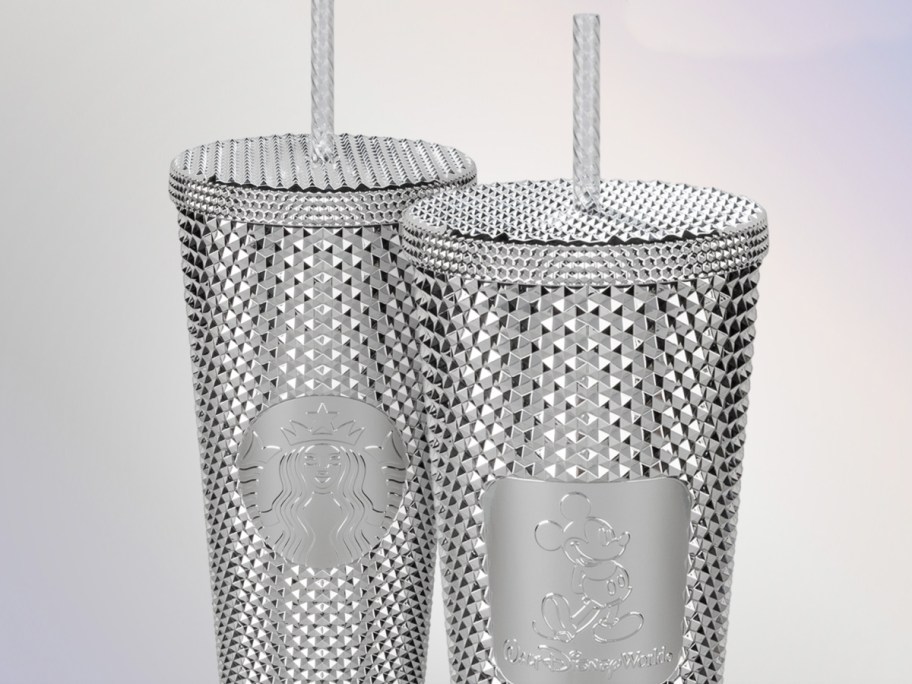 two silver studded disney tumblers with straws