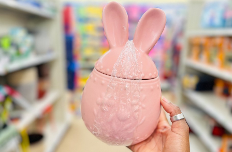 hand holding pink bunny ear jar 