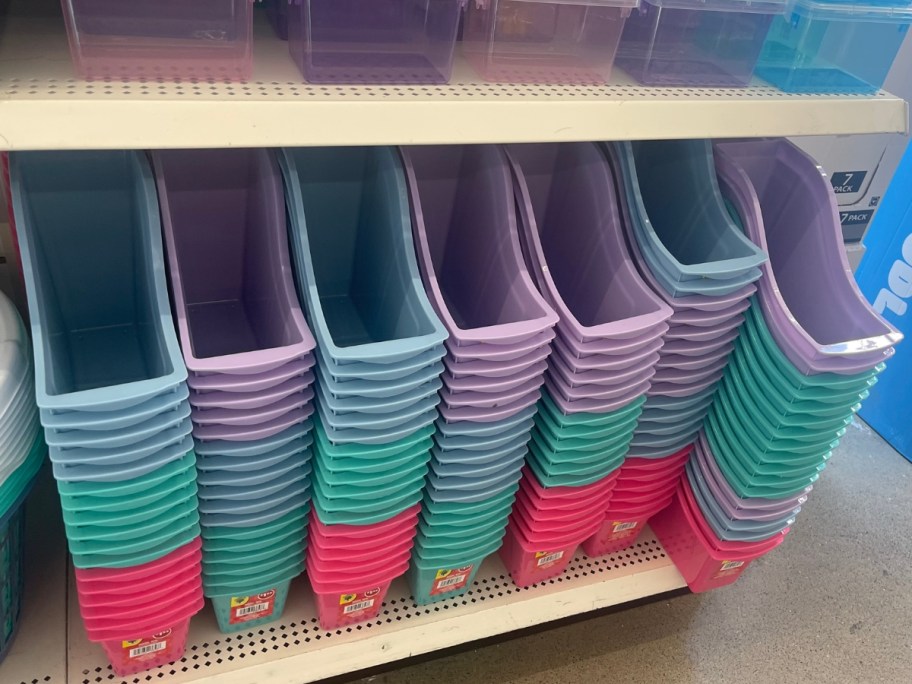 shelf with various colors of plastic book bins