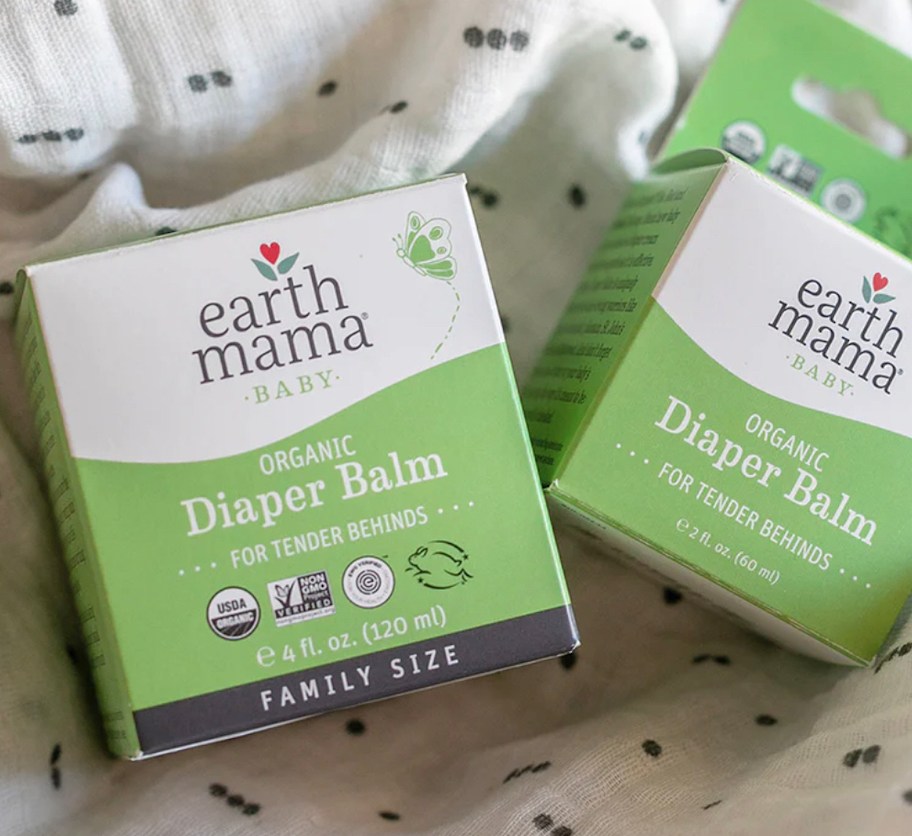 two packs of earth mama organic diaper balm on baby blanket