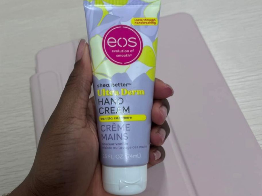 hand holding a tube of eos Hand Cream in the Vanilla Cashmere scent