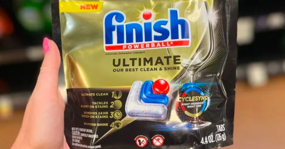 hand holding finish ultimate dishwasher detergent bag