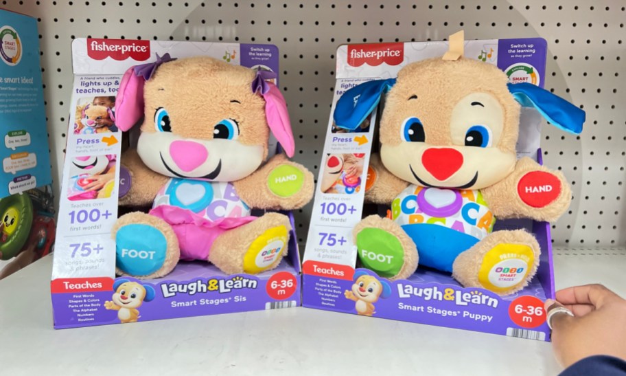 fisher price laugh and learn puppy and sis side by side in their packaging on a store shelf