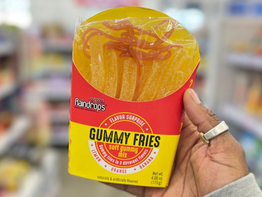 A hand holding a five below Gummy fries
