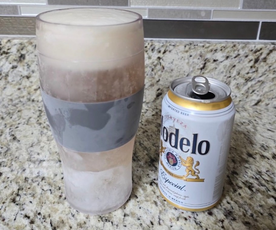 frozen beer glass with open can of modelo beer on counter
