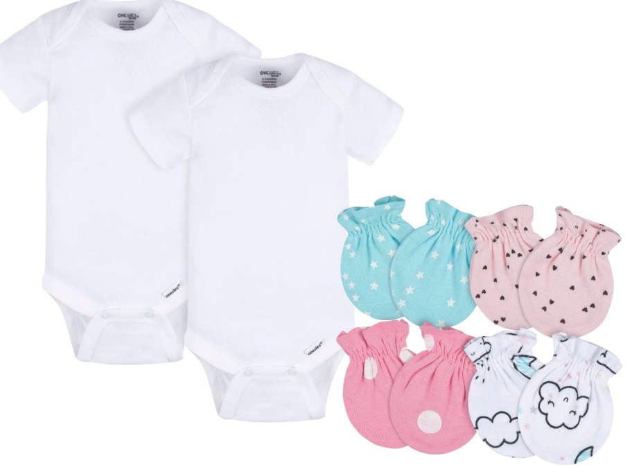 two white baby onesies next to 4 baby mittens in pink and blue girly prints
