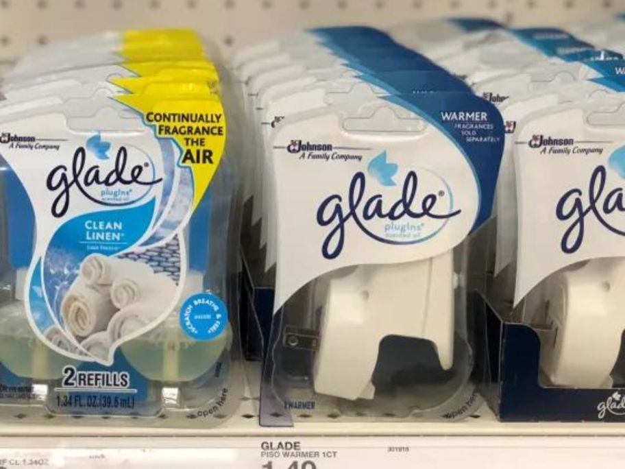 boxes of glade plug in on shelf 